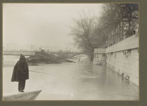 Flooded banks of the Seine, destroyed bridges and a fisherman during the flooding of Paris