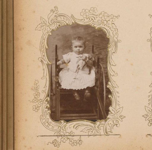 Portrait of a Seated Toddler with a Doll