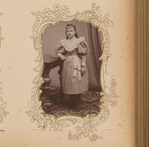 Portrait of a Girl Standing by a Table with a Book
