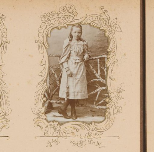 Portrait of a girl standing by a fence