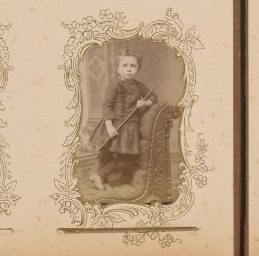 Portrait of a Child Standing on a Chair with a Walking Stick