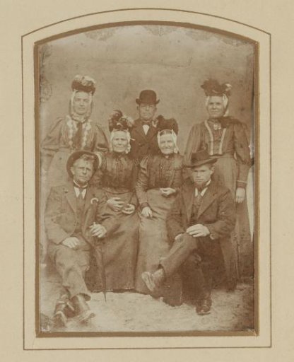 Group portrait of three men and four women in traditional dress