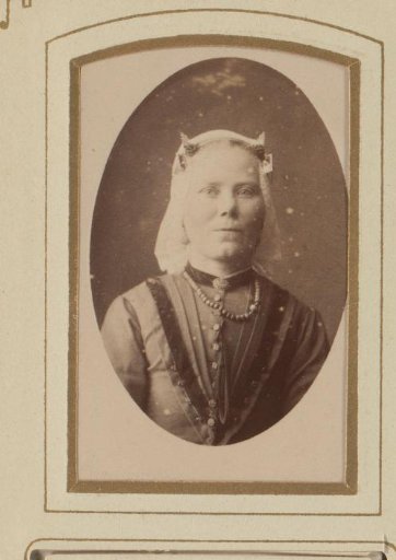 Portrait of a woman in a white linen cap and necklace