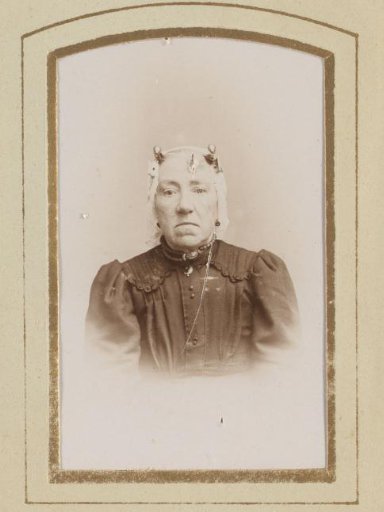 Portrait of a woman in a white traditional cap
