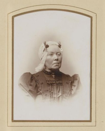 Portrait of a woman with a white traditional dress cap