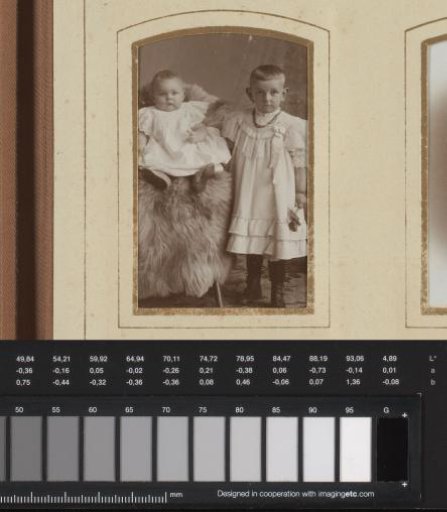 Portrait of a sitting baby and a standing girl