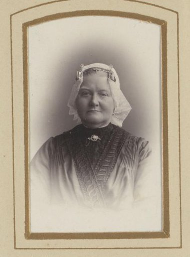 Portrait of a woman with a white traditional dress cap