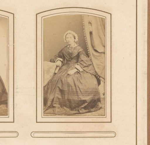Portrait of a seated woman with a headdress