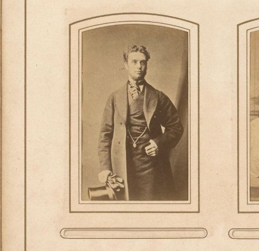 Portrait of a standing man, with hat and gloves in hand