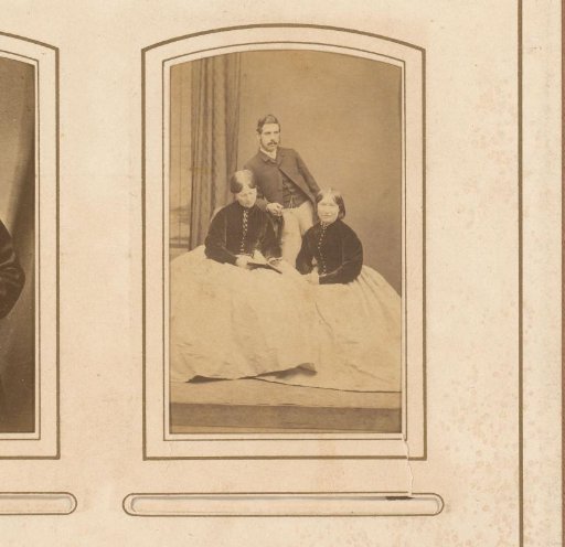 Portrait of two seated women and a man