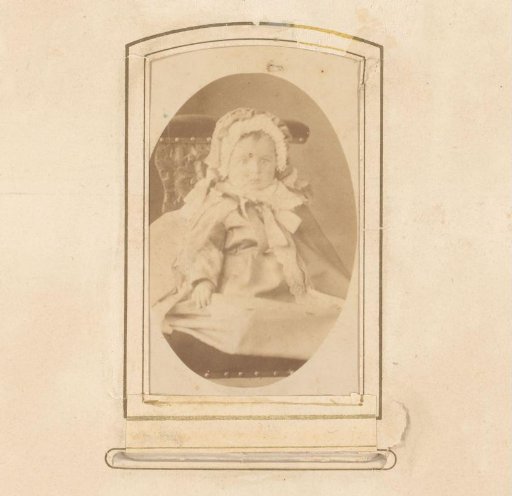 Portrait of a toddler sitting on a chair