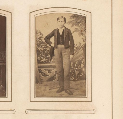 Portrait of a boy with a cap in his hand