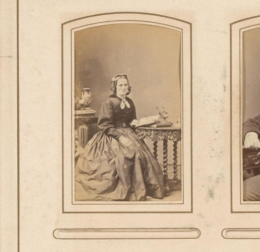 Portrait of a seated woman with a book on a table