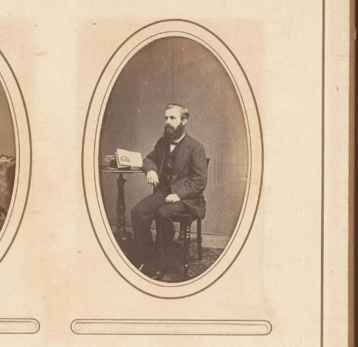Portrait of a Man Sitting at a Table with an Open Book