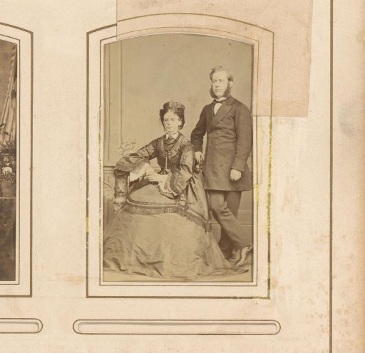 Portrait of a man with sideburns and a seated woman