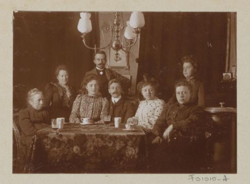 Men and women behind a table in a living room