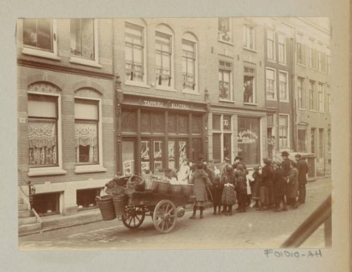 Children and adults watching work at a tavern and off-licence and waffle bakery Jac. van der Zee