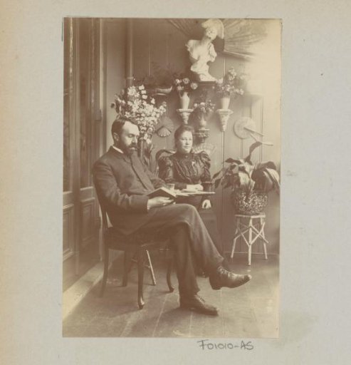 Woman and reading man, sitting in a conservatory