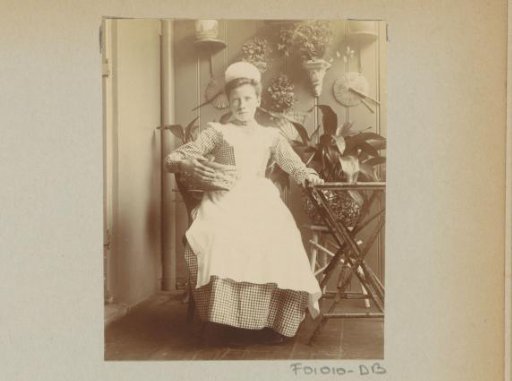 Maid seated in a conservatory with a basket on her arm