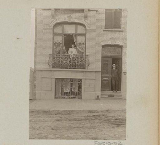 Man, three women and a baby in a door and window opening