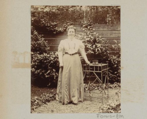 Woman standing in a garden at a table