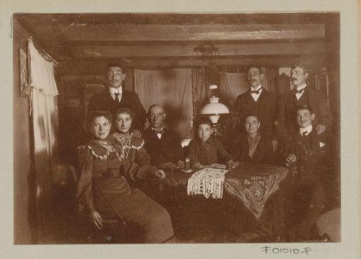 Men and women behind a table in a room with a beam ceiling