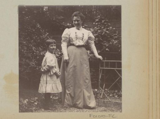 Woman and a girl standing in a garden