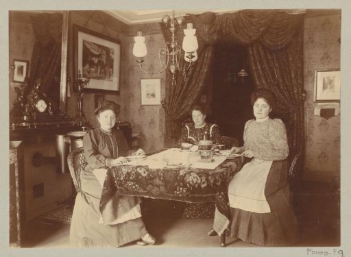 Three women seated at table at a meal