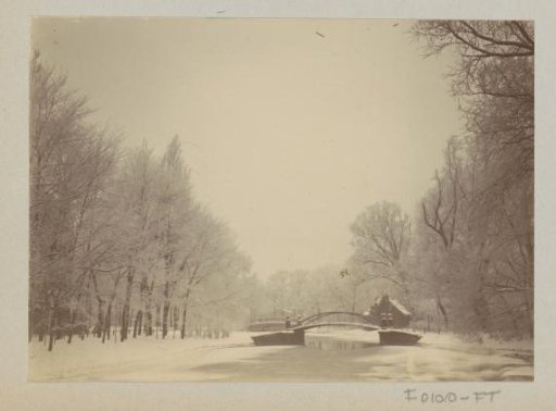 Bridge over the frozen Plantage Muidergracht with snow