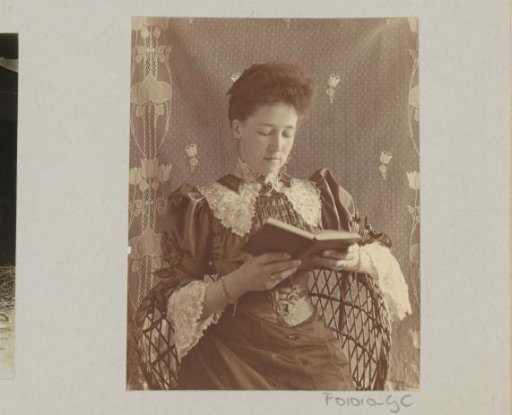 Woman reading a book, seated