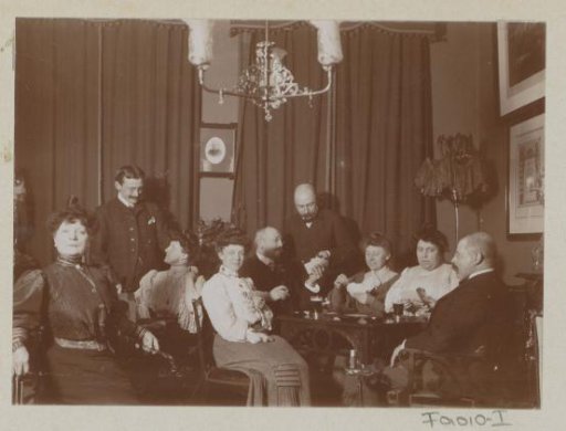 Company playing cards around a table
