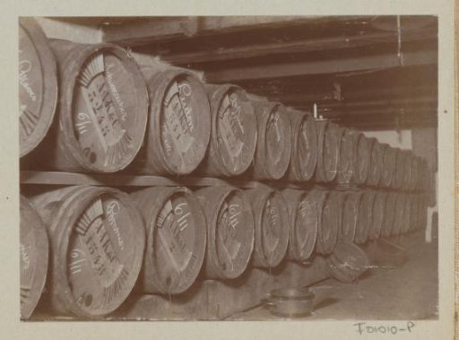 Wooden casks with drink on a rack