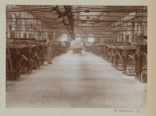 Interior of a factory hall with machines and a worker