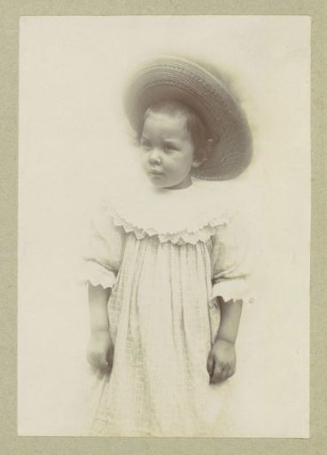 Portrait of a child in a dress and a sun hat
