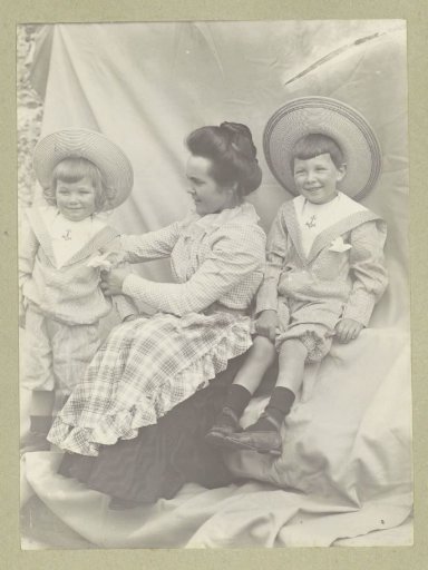 Portrait of a woman with two children wearing sun hats and sailor suits