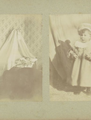 Portrait of a young child in a dress with a cap