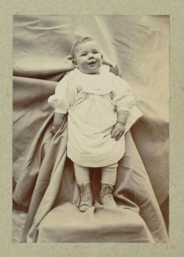 Portrait of a young child in a shirt with laced boots