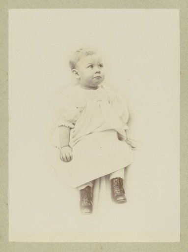 Portrait of a young child in a dress with laced boots