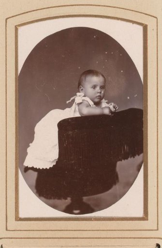 Portrait of a baby, leaning on a chair