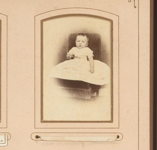 Portrait of a baby, seated on a chair