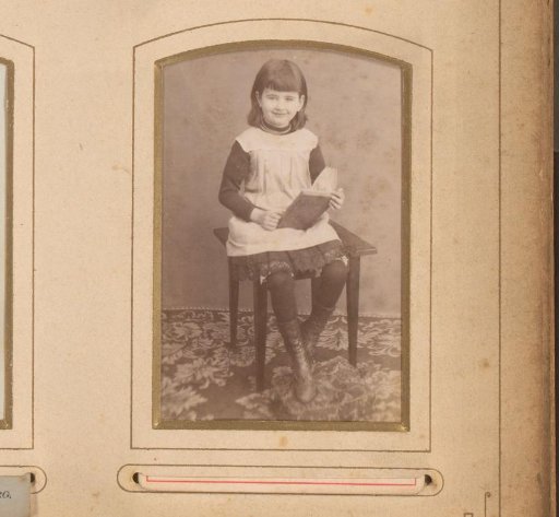 Portrait of a girl seated with a book