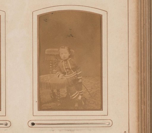 Portrait of a boy leaning on a chair