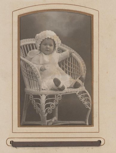 Portrait of a baby, seated on a chair