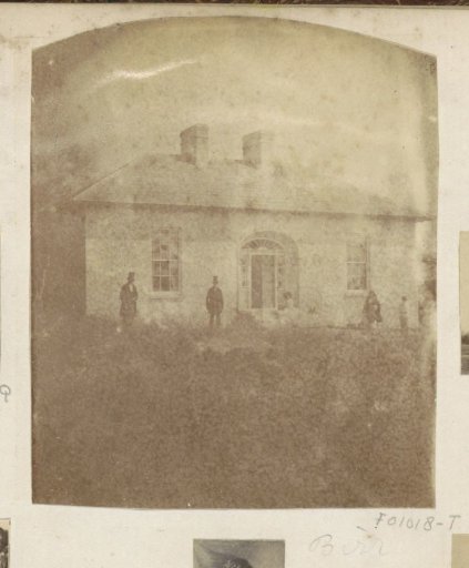 People in front of a house, presumably in Birr