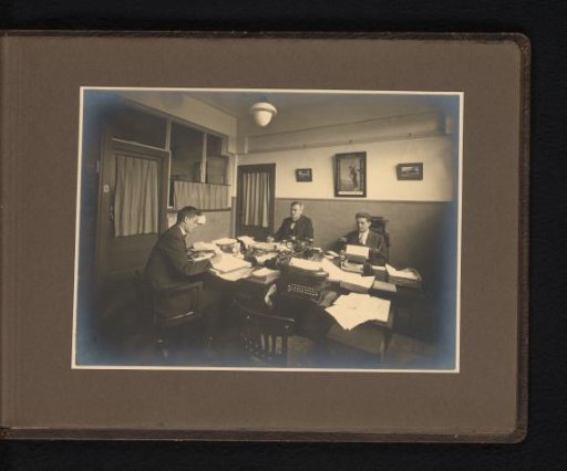 Three men in an administrative office