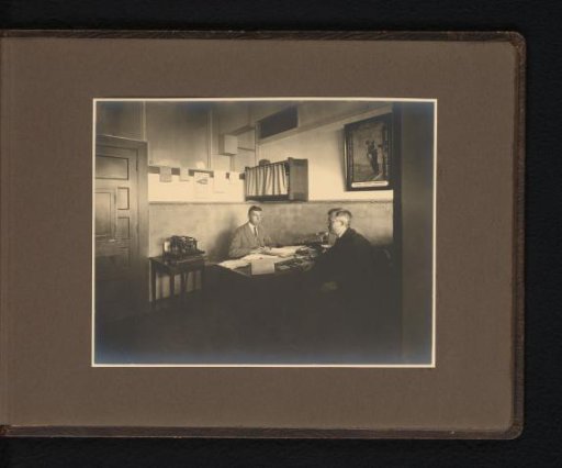 Two men at a desk in an office