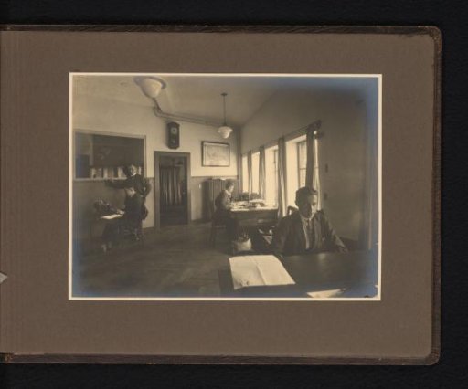 Four men in an administrative office