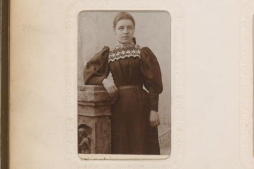 Portrait of a woman standing by a pillar