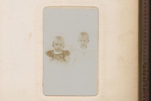 Portrait of a Baby in a White Dress and Cap