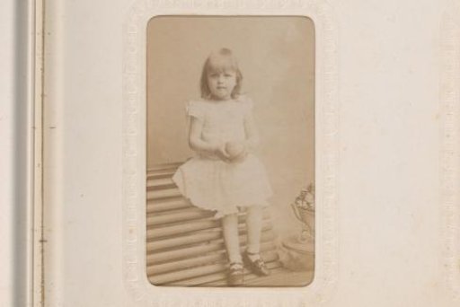 Portrait of a Standing Girl in a White Traditional Cap